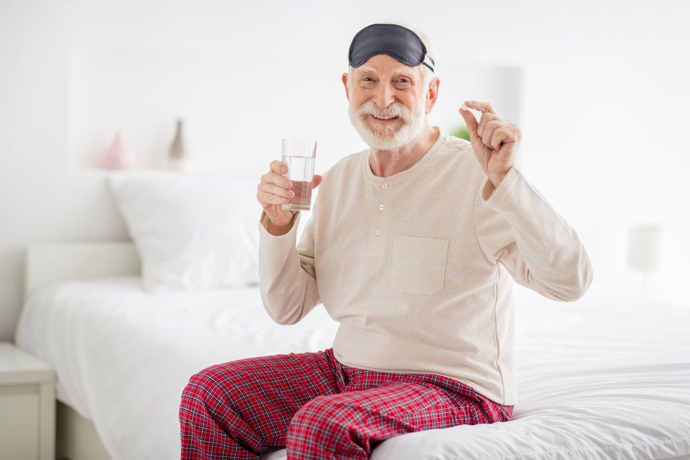 old man holing zenutri vitamin pill ready to take it and go to bed