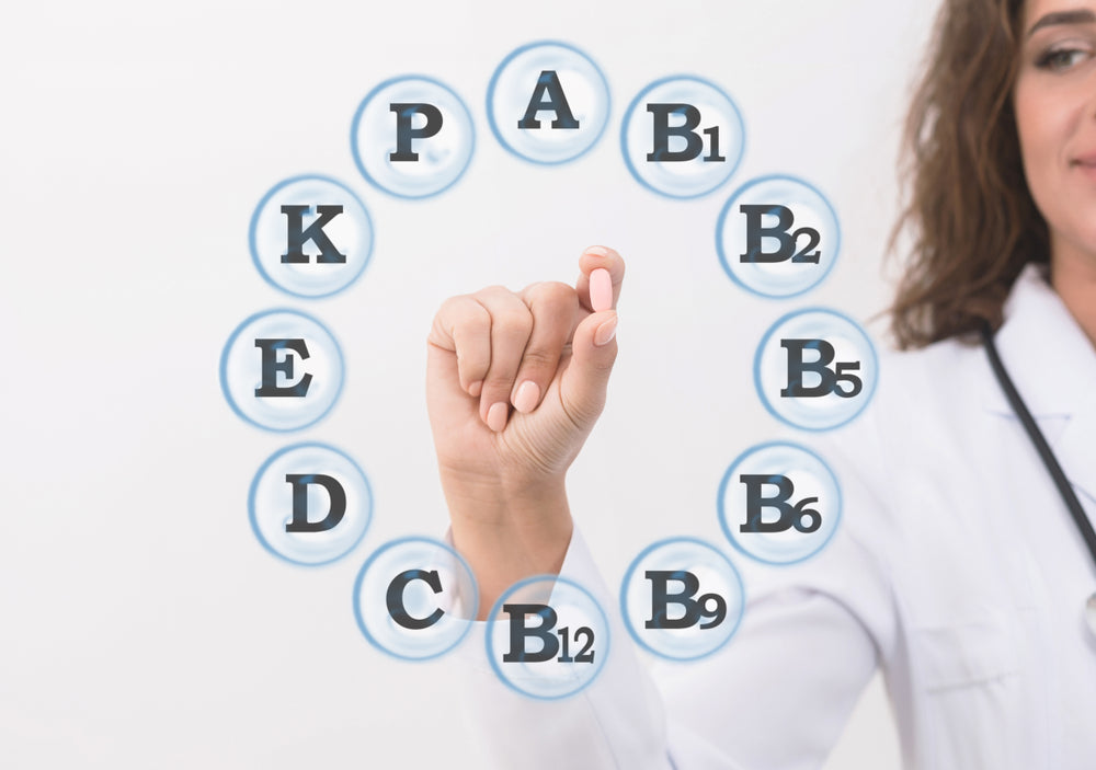 female Dr at zenutri pointing out the vitamin and holding zenutri vitamin pill